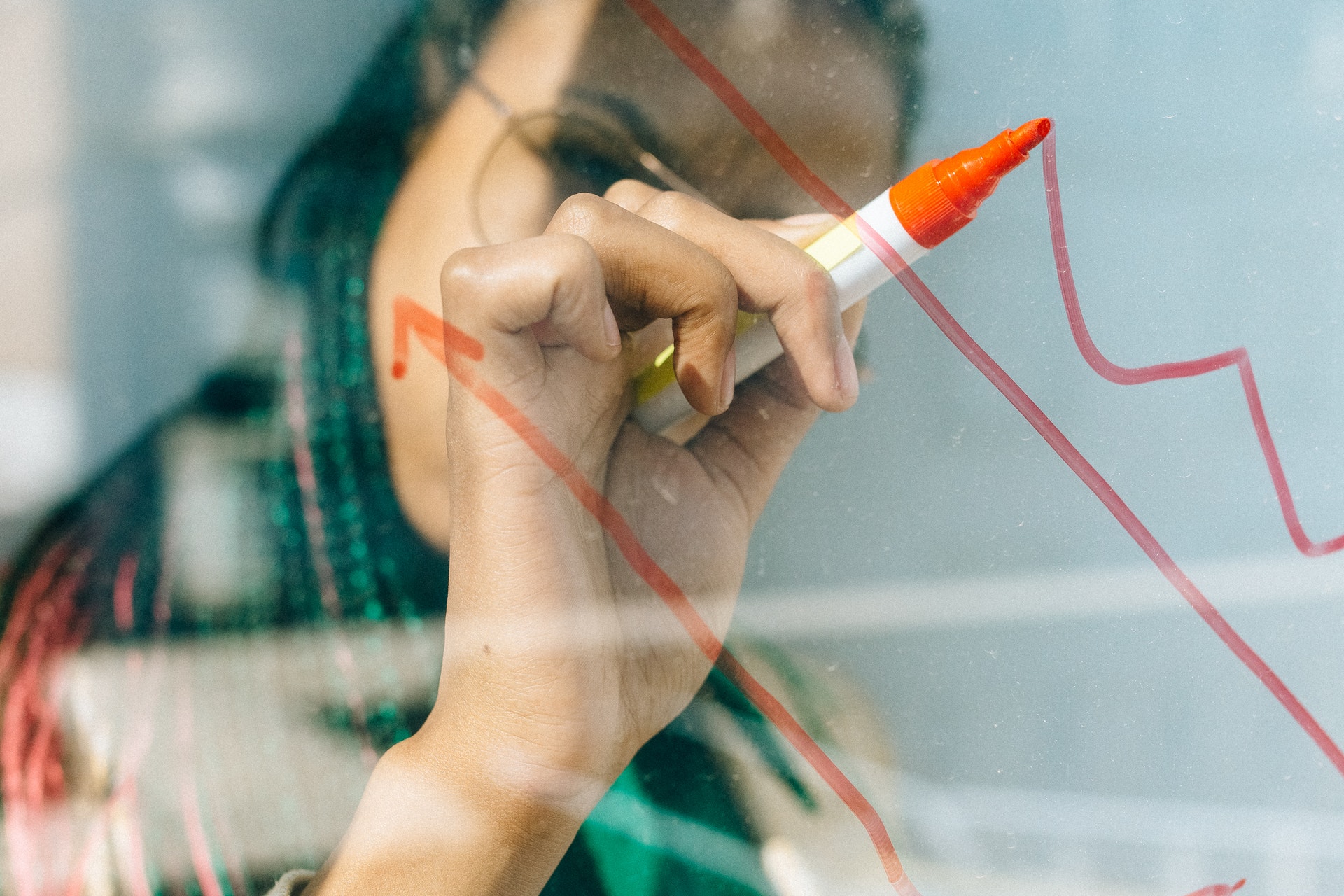 woman writing on whiteboard