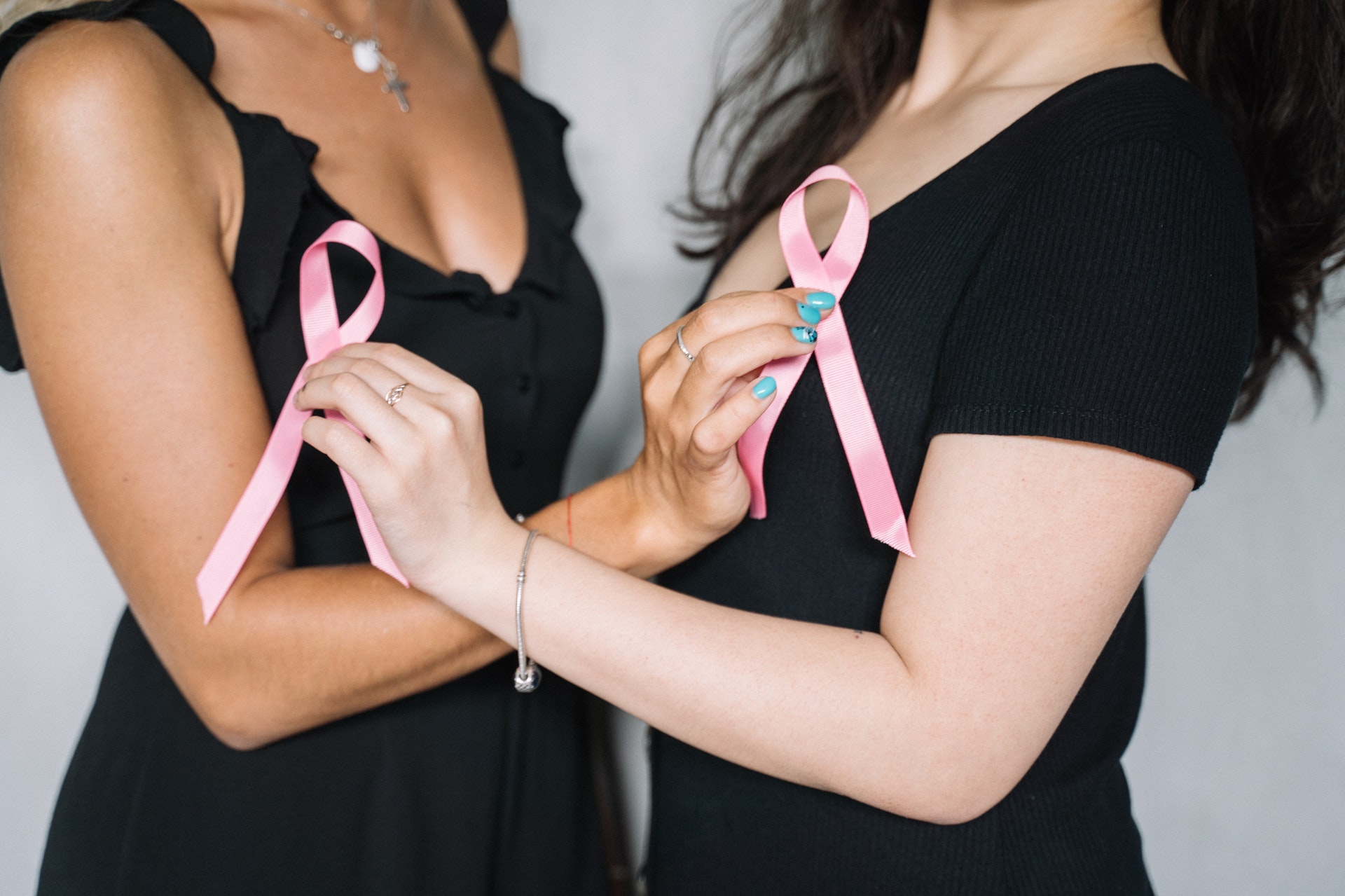 2 women with pink ribbons