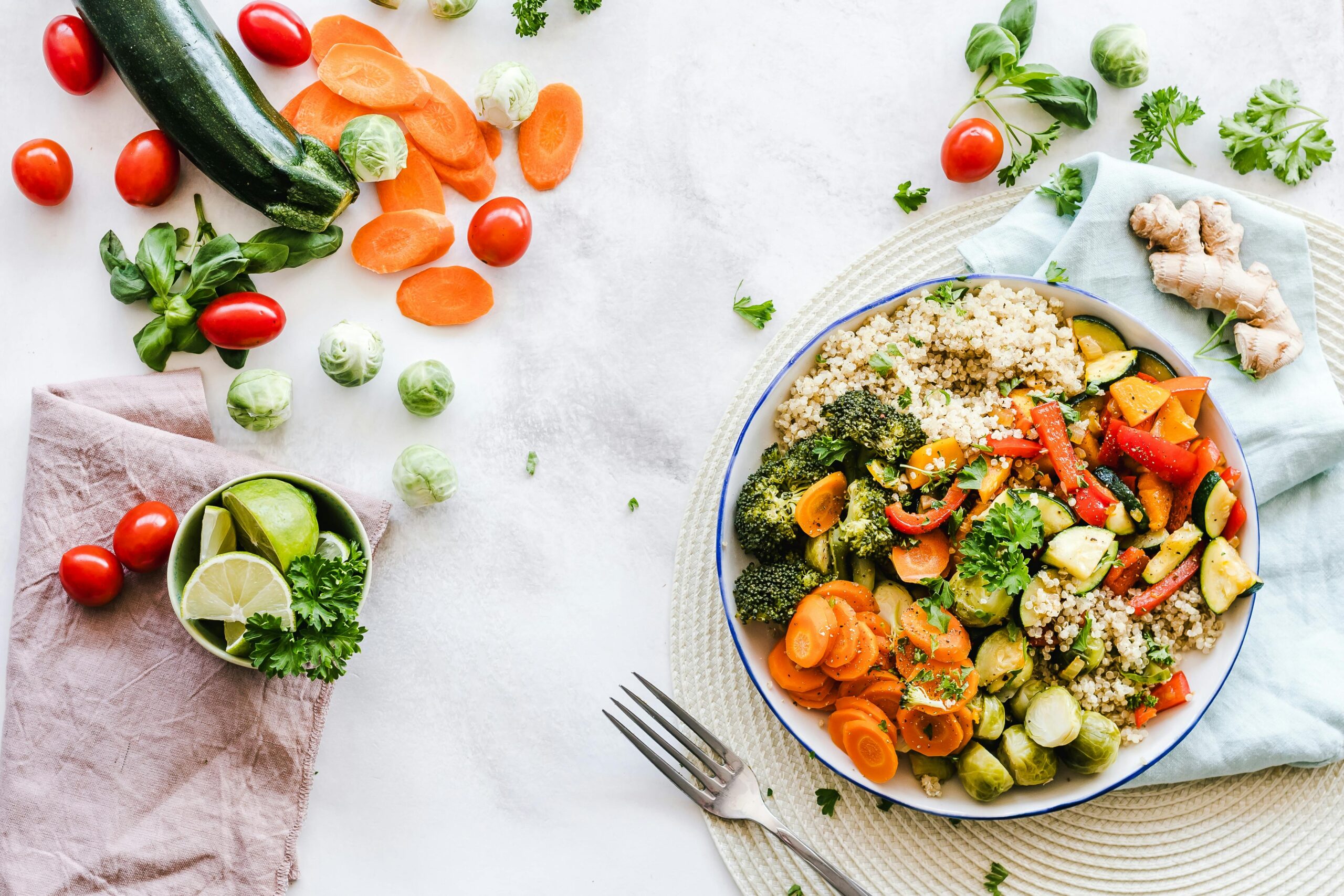 a salad bowl surrounded by various fruits and vegetables