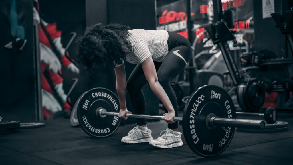 Woman prepares to deadlift barbell from the ground