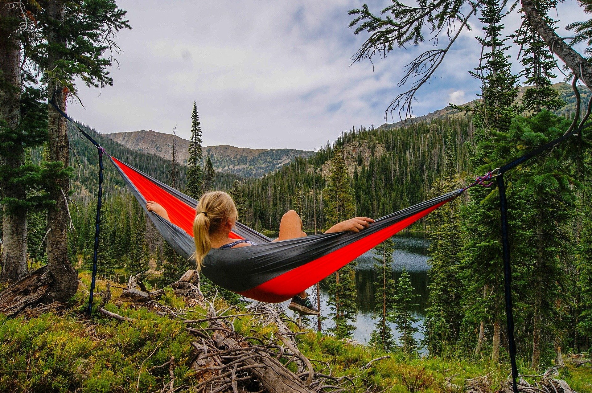 woman in hammock overlooking valley and river below